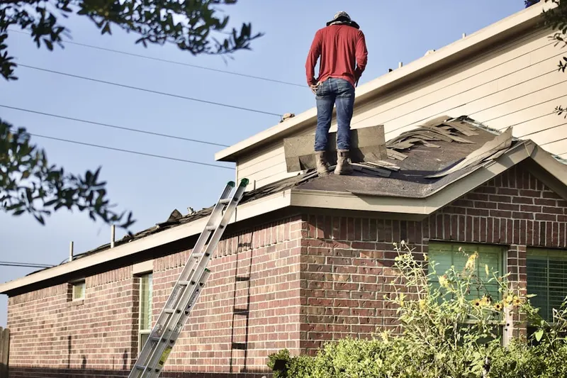 Professional roofer working on a residential roof in Coosaw